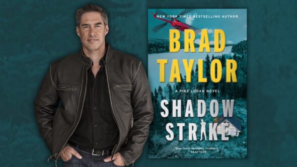 Author Brad Taylor with short dark hair and some grey on the sides. He's wearing a brown leather jacket open with a black button up shirt and jeans. Features the book cover of Shadow Strike by Brad Taylor.