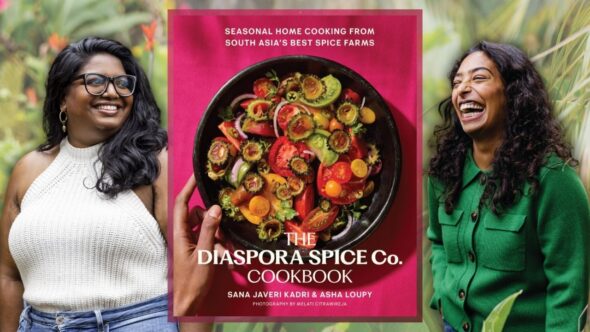 Authors Sana Javeri Kadri and Asha Loupy smiling in the backgroud. Asha with long dark hair over her shoulder wearing glasses, knit tank top and jeans. Sana with long dark curly hair wearing a green button long-sleeved top. The book cover of The Diaspora Spice Co. Cookbook is in the center of the image.