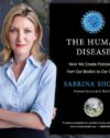 Features the book cover of The Human Disease by Sabrina Sholts. The author wearing a blue button up shirt stands with her arms across her abdomen.