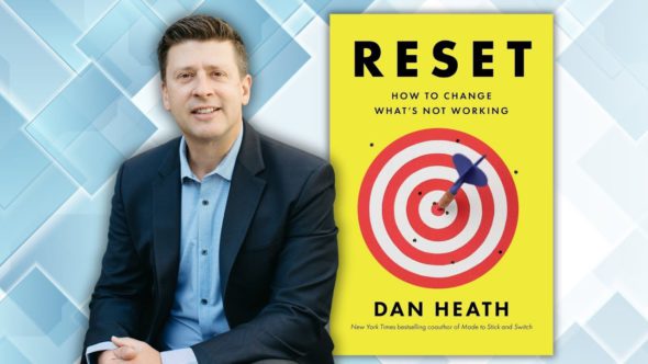 The author in a light blue button up shirt and dark blue blazer. Features the book cover of Reset : How to Change What's Not Working by Dan Heath.