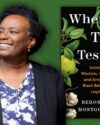 Author, Beronda Montgomery, with short black hair, and a big smile on her face, wearing a blue and white button up blouse and navy cardigan. Green background with leaves. Book cover of When Trees Testify by Beronda Montgomery.